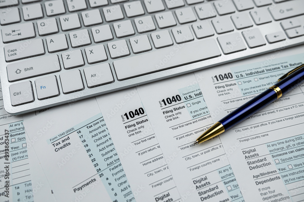 pen with computer keyboard on business finance tax form, office desk pen with computer keyboard on business finance tax form, office desk