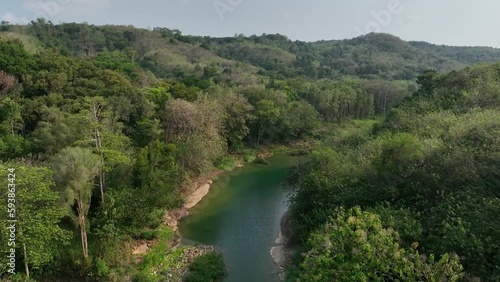 Drone passing along sections of the River Oyo near the Gantung Wanagama Bridge (Jemabatan) at the start of the dry season - with matching foliage.  Passing over or near to the bridgee photo