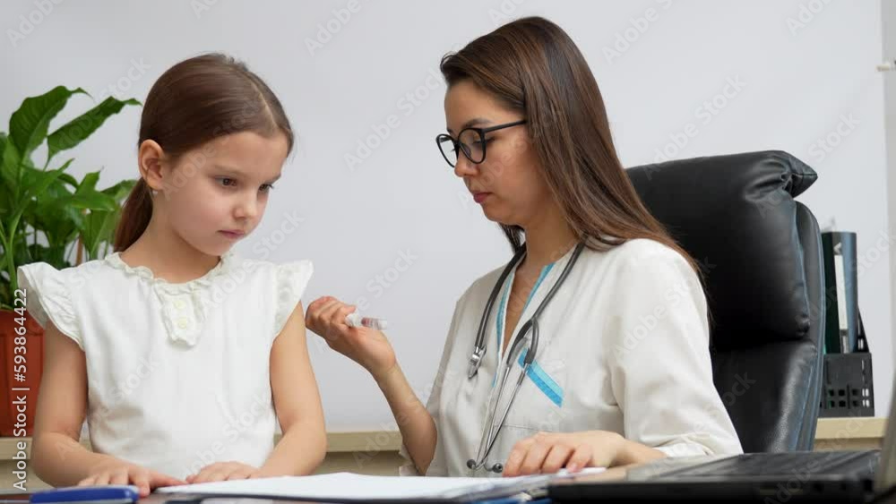 Female doctor using insulin injection pen for diabetic girl Female doctor using insulin injection pen for diabetic girl