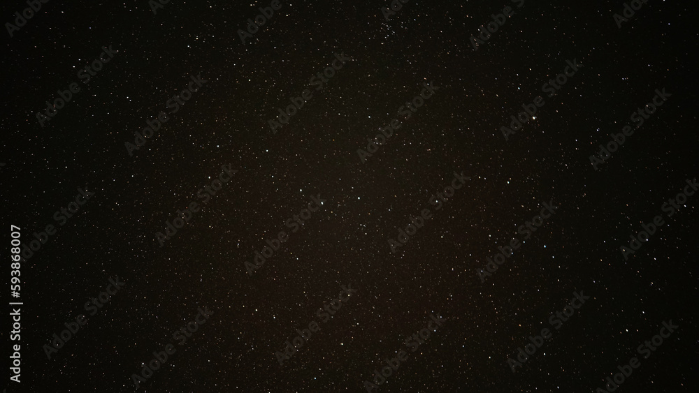 A starry sky on a black night sky. Zodiac signs. A large number of stars scattered across the sky like grains of sand on the seashore. Some stars are big, others are smaller. Light points.