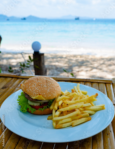 lunch at the beach of Koh Kradan island in Thailand with thai food and hamburg with french fries