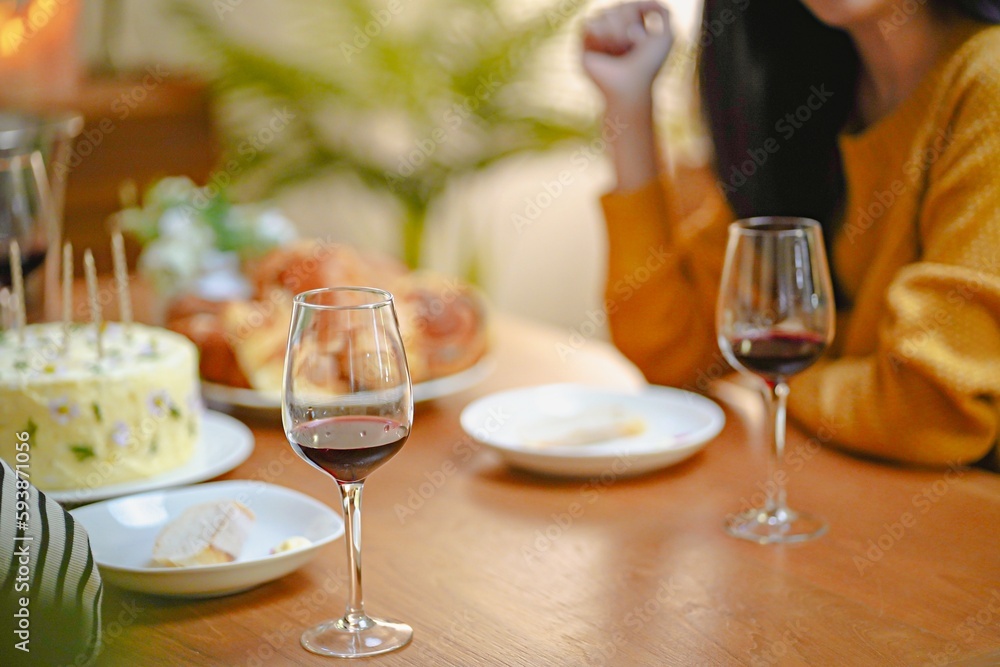 Cheerful friends enjoying home Birthday holiday party. Asian Friends cheering drinking red wine celebrating New Year party. Cheerful friends enjoying home Birthday holiday party. Asian Friends cheering drinking red wine celebrating New Year party.