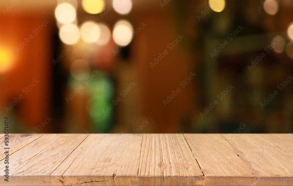 Empty wooden table in front of abstract blurred background of coffee shop . can be used for display or montage your products.Mock up for display of product Empty wooden table in front of abstract blurred background of coffee shop . can be used for display or montage your products.Mock up for display of product