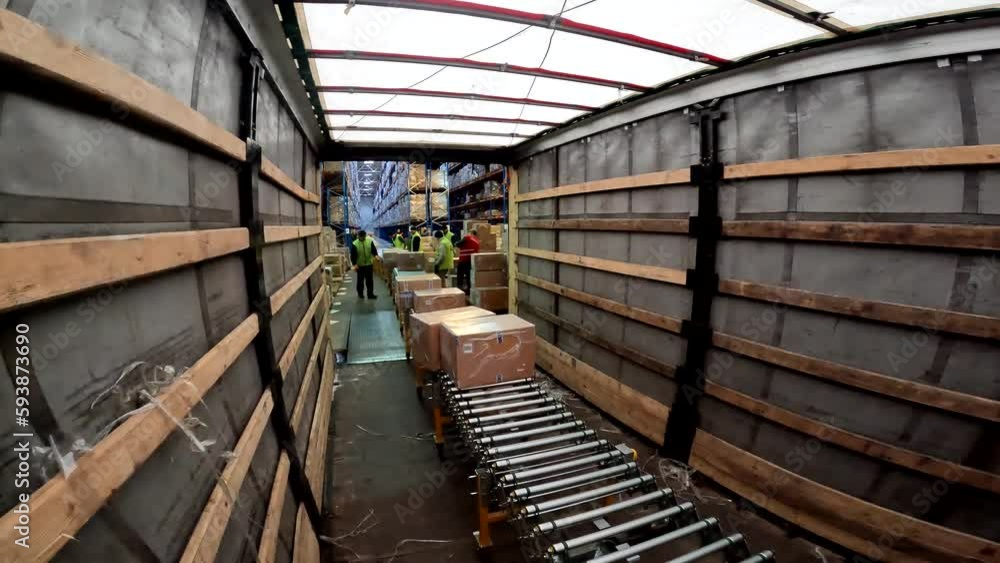 Goods are unloaded from the truck. The process of unloading goods from ...