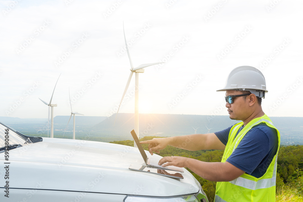 Electrical engineer checking the operation of wind turbines generating electricity