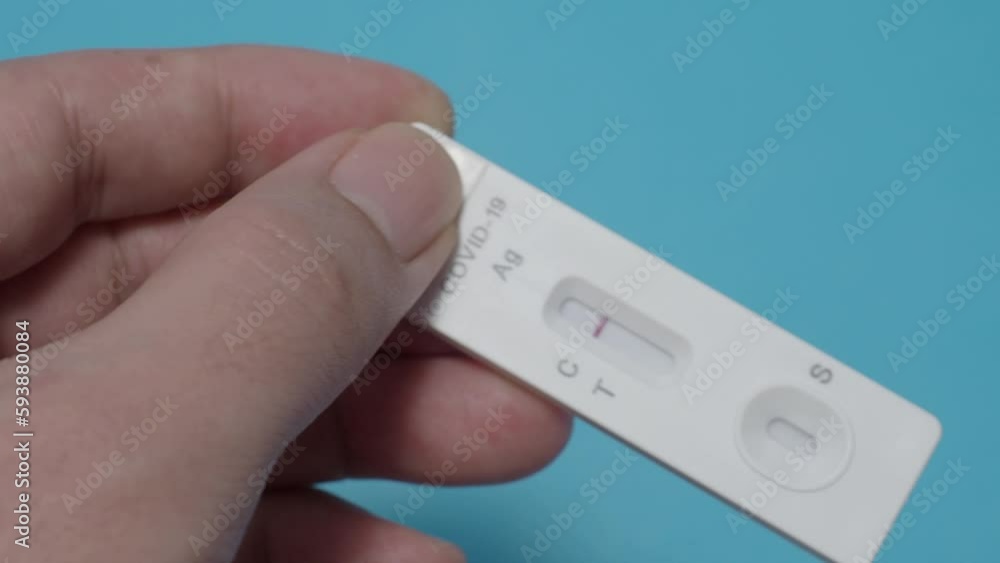 POV of Man hands using Rapid antigen test kit or ATK and blue background. Covid 19 rapid antibodies test kit for detecting antibodies and immunity in 15 minutes. Easy Coronavirus protective check up. POV of Man hands using Rapid antigen test kit or ATK and blue background. Covid 19 rapid antibodies test kit for detecting antibodies and immunity in 15 minutes. Easy Coronavirus protective check up.