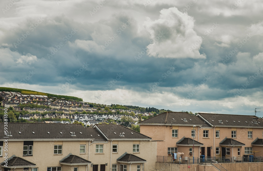 Residential complex in Derry, Northern Ireland with numerous villas and semi detached houses expanding on a hill. Londonderry urban area stretching on high ground with rows of houses and neighbours Residential complex in Derry, Northern Ireland with numerous villas and semi detached houses expanding on a hill. Londonderry urban area stretching on high ground with rows of houses and neighbours