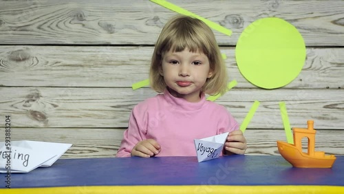 Baby playing with a paper boat