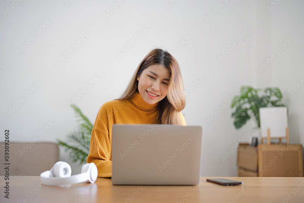 Asian business woman using headphone and laptop video conference meeting online work at home. Asian business woman using headphone and laptop video conference meeting online work at home.