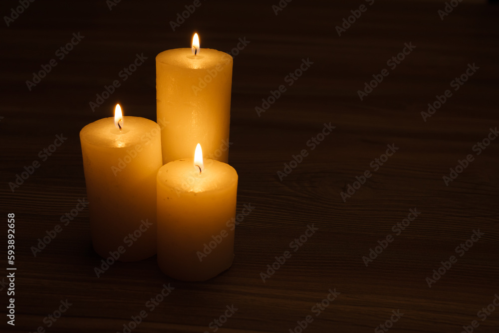 three burning candles in the semi-darkness three burning candles in the semi-darkness