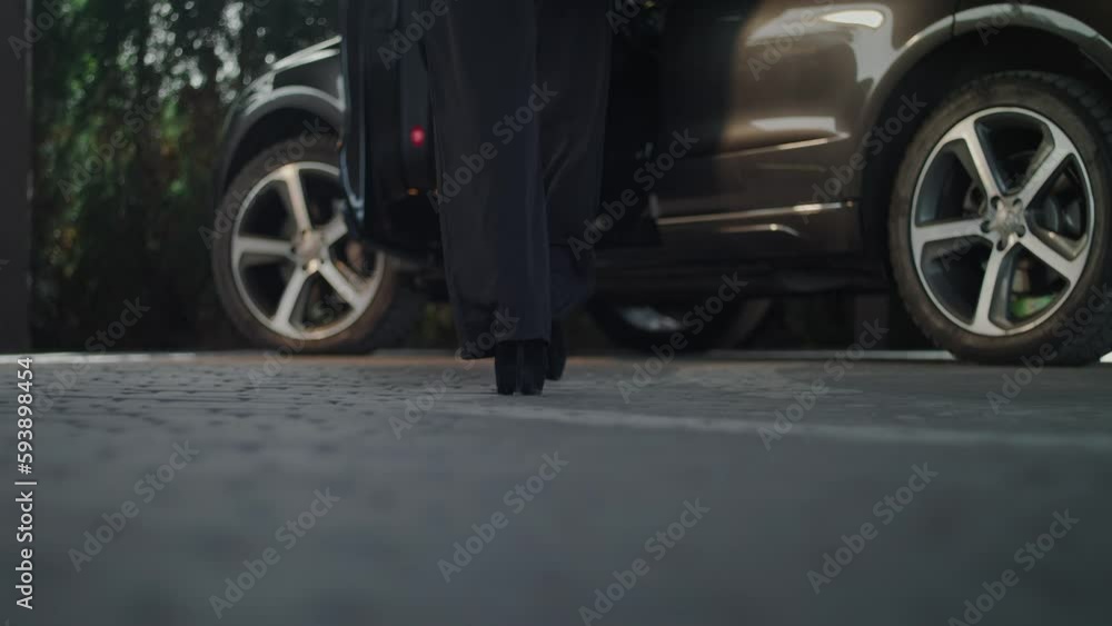 The camera is on the ground showing us the view from below. We see a close-up of a woman�s legs. She wears high heels and gets inside her car. The camera stays on the ground. The camera is on the ground showing us the view from below. We see a close-up of a woman�s legs. She wears high heels and gets inside her car. The camera stays on the ground.