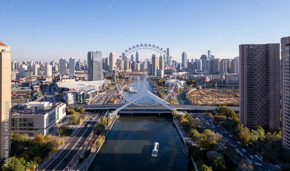 Aerial shot of the Tianjin Eye over the lake amid the skyscrapers, China