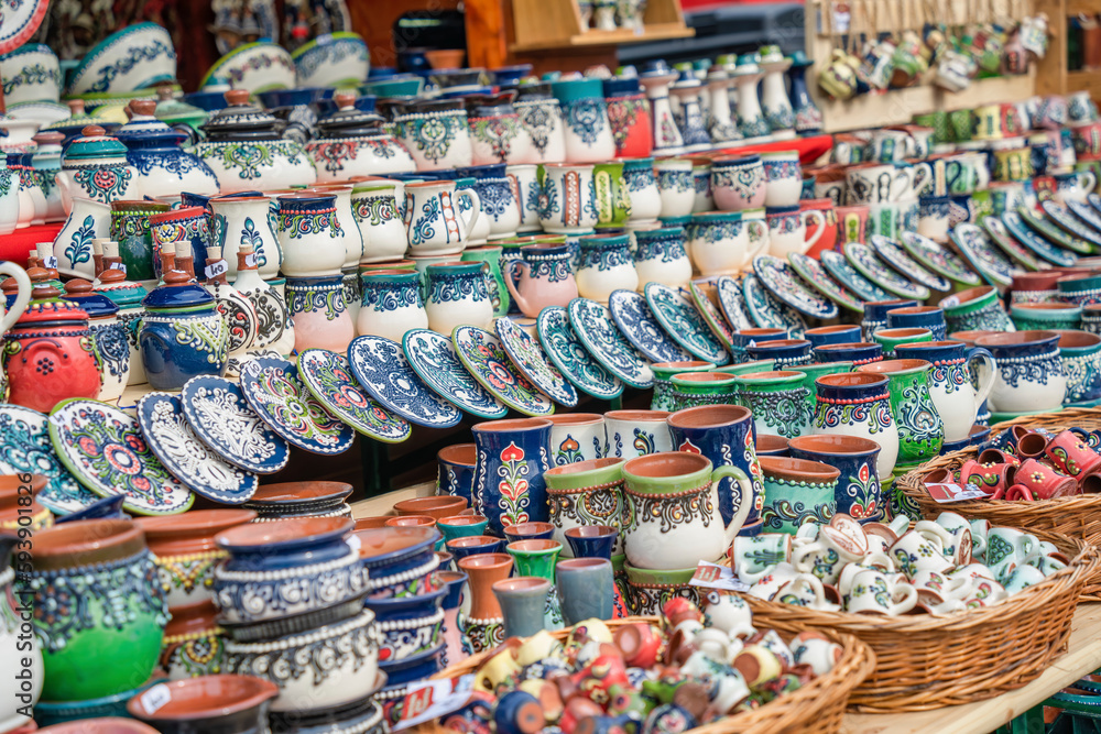 Traditional romanian handmade ceramic pottery plates with rustic authentic decoration paintings on display.