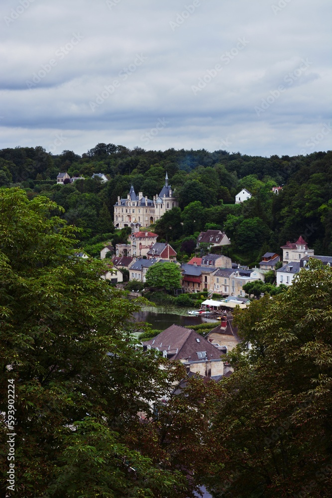 Vertical shot of Chateau de Jonval between green trees
