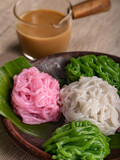 Indonesian (Betawi) traditional desert Kue Putu Mayang served on a clay plate. It's an Indonesian Betawi string hopper dish made of starch or rice flour and coconut milk.
