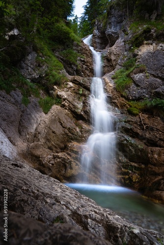 Vertical long exposure shot of a beautiful waterfall in the Bavarian Alps  Germany