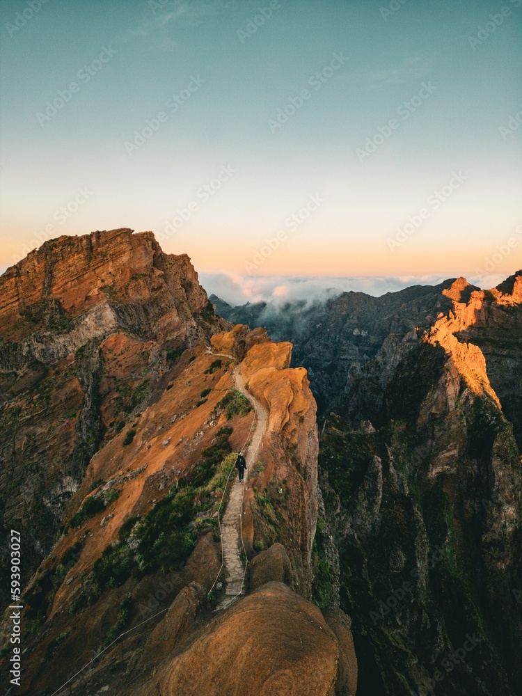Fototapeta premium Drone vertical view of person walking on the trail connects the highest points of the island
