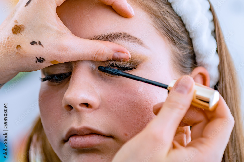 Obraz premium Young woman in a beauty salon. Woman doing make-up in a beauty salon