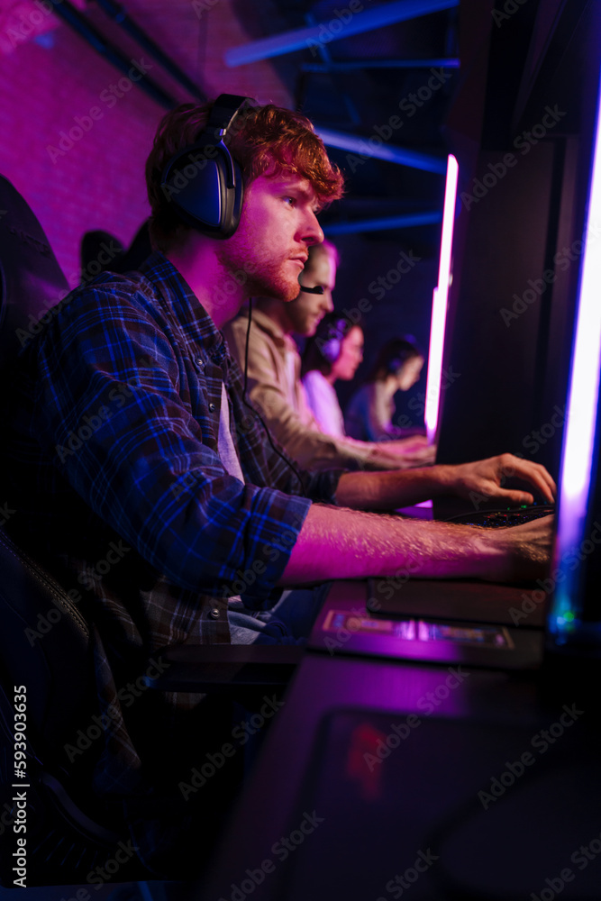 Team of gamers playing online game on championship in cybersport club Team of gamers playing online game on championship in cybersport club