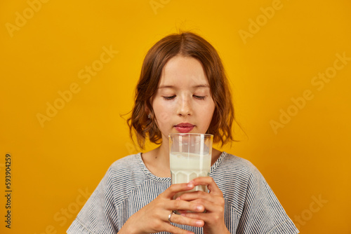 Pretty teen girl, child with a fresh glass of milk