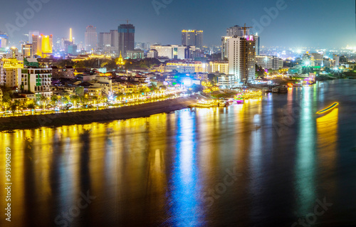 Phnom Penh riveride at Night and the Royal Palace,lit up,viewed from eastern side of Tonle Sap river,Cambodia.