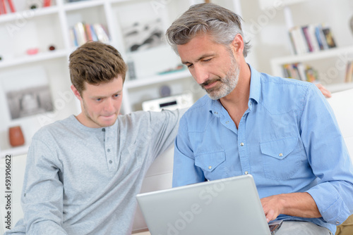 father and son with technology