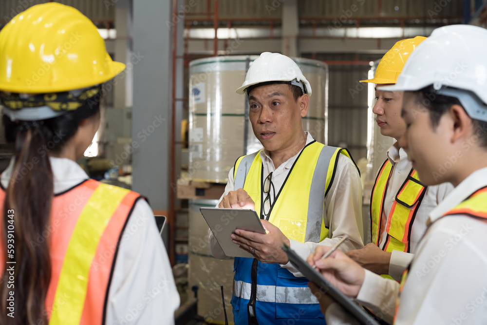 Manufacturing industrial concept. Asian male and female factory workers working and discuss at manufacturing production lines in factory during manufacturing process Manufacturing industrial concept. Asian male and female factory workers working and discuss at manufacturing production lines in factory during manufacturing process