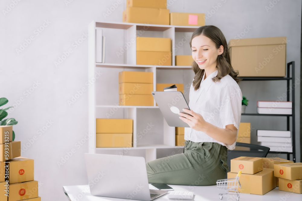 Small business entrepreneur SME freelance woman working at home office, boxs ,tablet and laptop online, marketing, packaging, delivery, e-commerce concept. Small business entrepreneur SME freelance woman working at home office, boxs ,tablet and laptop online, marketing, packaging, delivery, e-commerce concept.