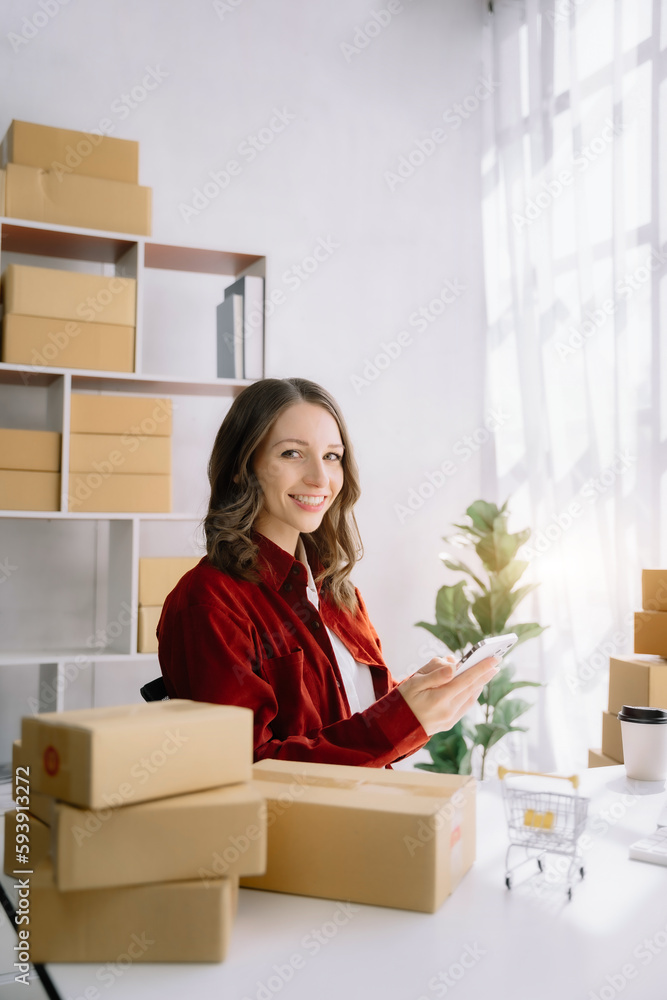 woman start up small business owner SME or freelance America woman working with box at home office. woman start up small business owner SME or freelance America woman working with box at home office.