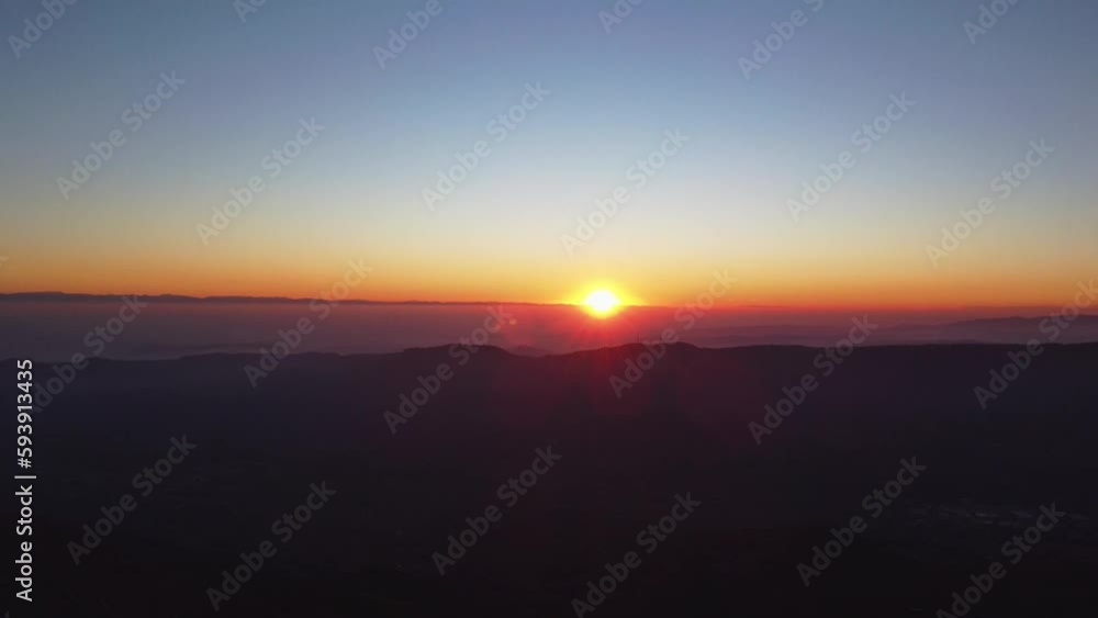 Drone shot over forested hills at sunset Drone shot over forested hills at sunset