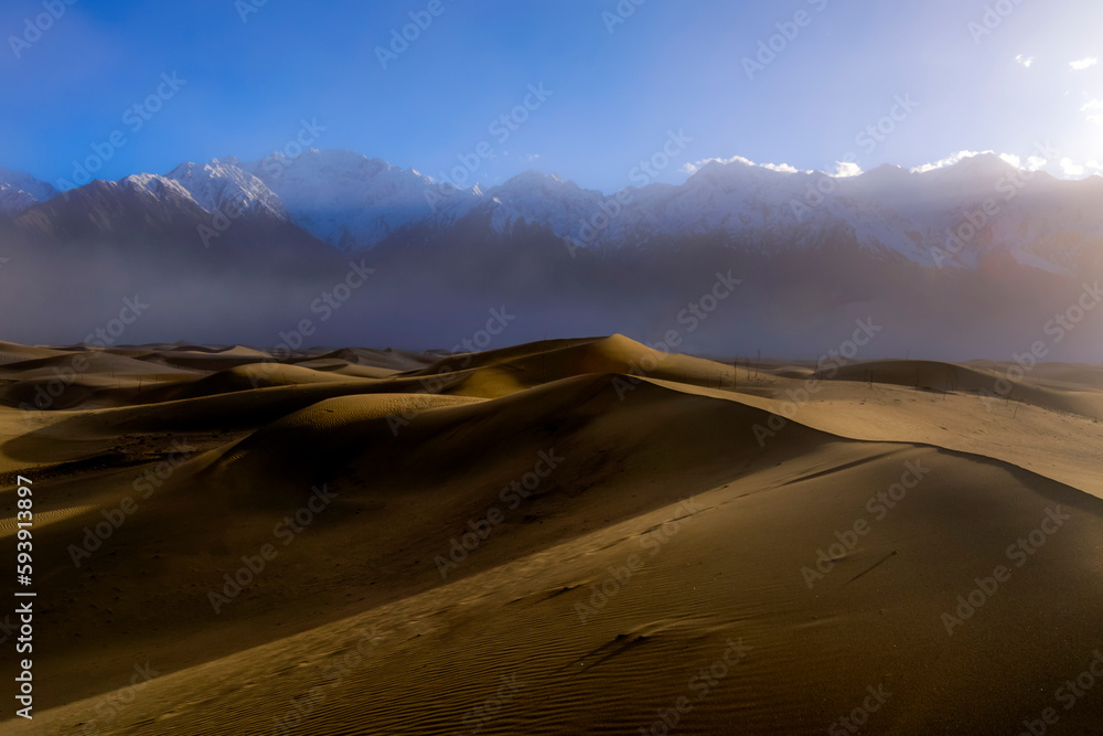 desert in the snow mountains, cold desert and snow peaks, landscape of dune  desert  and snow caped mountains 