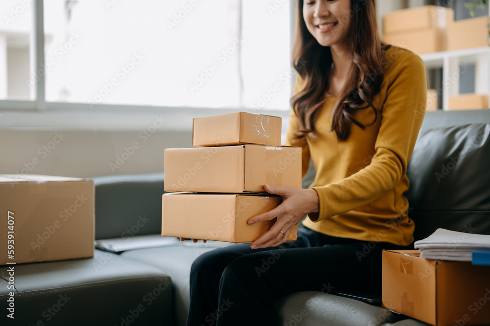 Business owner woman prepare parcel box and standing check online orders for deliver to customer on tablet, laptop Shopping Online concept... Business owner woman prepare parcel box and standing check online orders for deliver to customer on tablet, laptop Shopping Online concept...