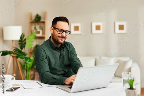 Young man working in office with laptop