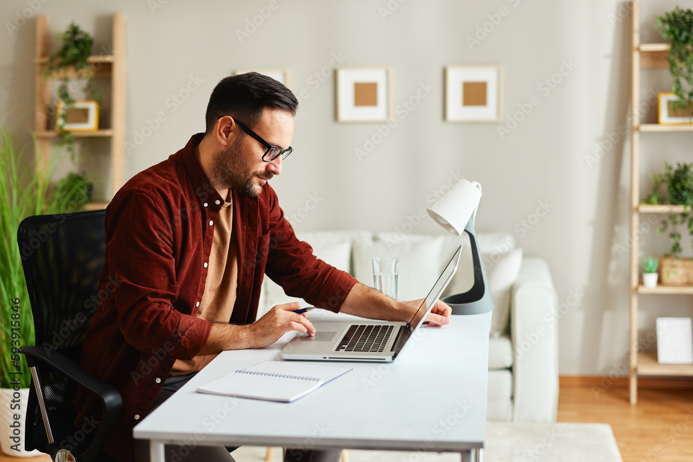 Young man working in office with laptop Young man working in office with laptop