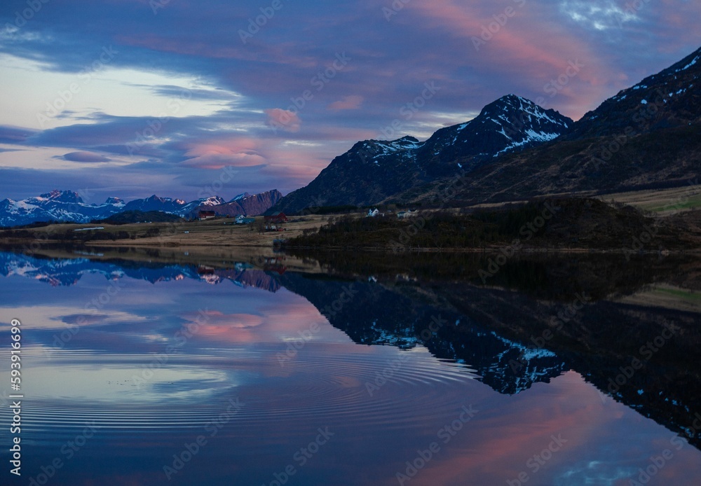 Reflection of beautiful mountain landscape at Unstad beach in Lofoten, Norway