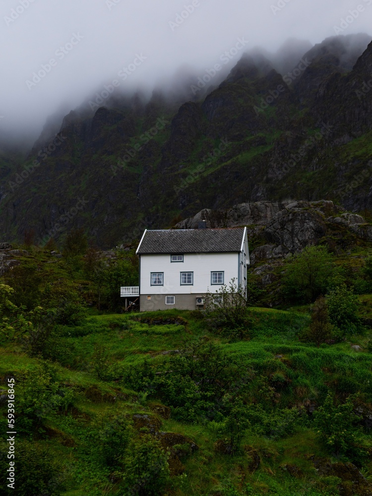 Lone white house on the slope of a mountain in Lofoten, Norway