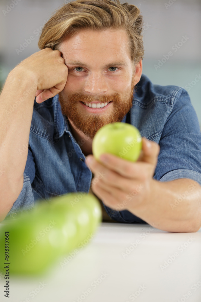 man holding a green apple man holding a green apple