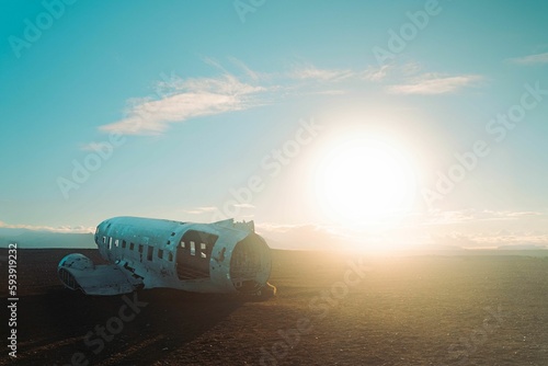 Abandoned and old plane in the field under the sun light. photo