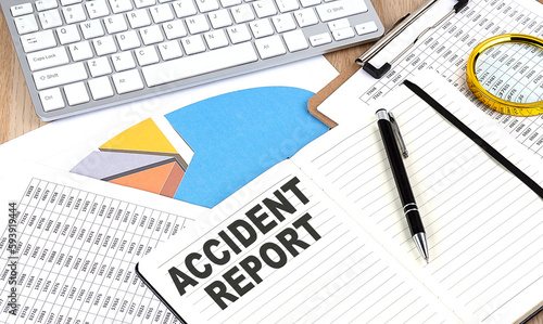 ACCIDENT REPORT text on notebook with chart and keyboard