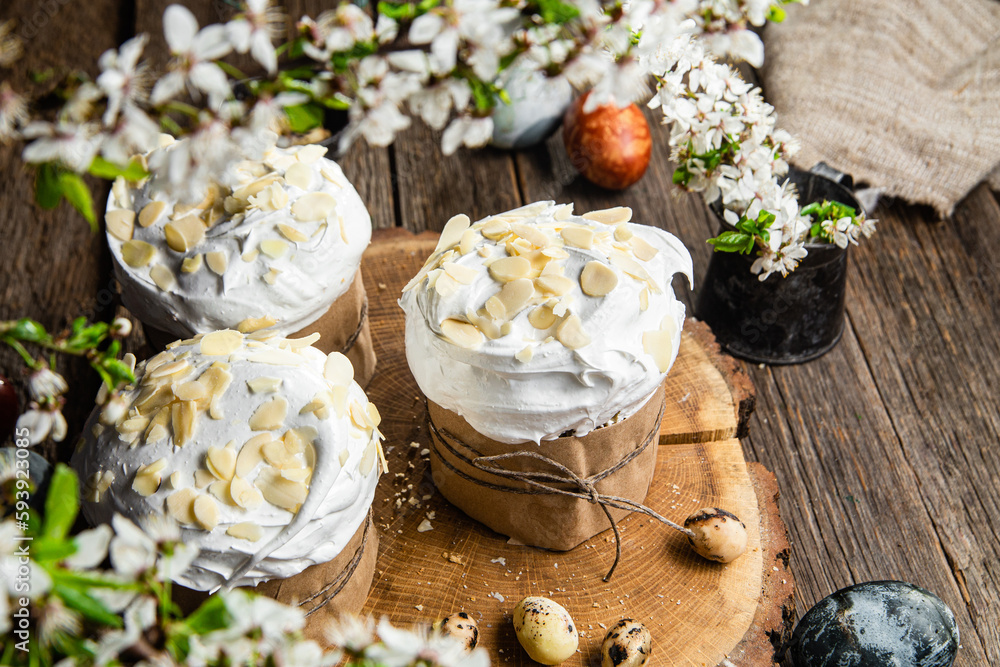 Easter cake with meringue and almond petals on a wooden background Easter cake with meringue and almond petals on a wooden background