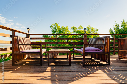garden furniture. Wooden terrace with tables for outdoor dining.