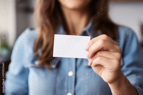 A woman holds a white business card in her hand. Mock Up. Generative AI