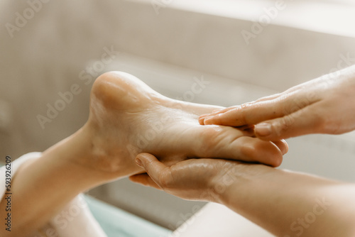 Wallpaper Mural Professional doctor physiotherapist makes a foot massage to a young woman. Therapeutic massage in the physiotherapist's office. Torontodigital.ca