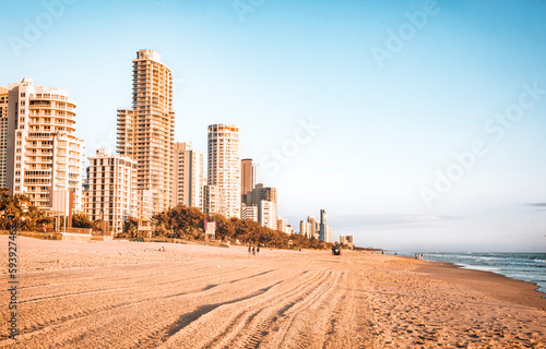 The scene of skyscrapers standing beside the beach in golden hours of the sunrise in the Surfers Paradise, Gold Coast 