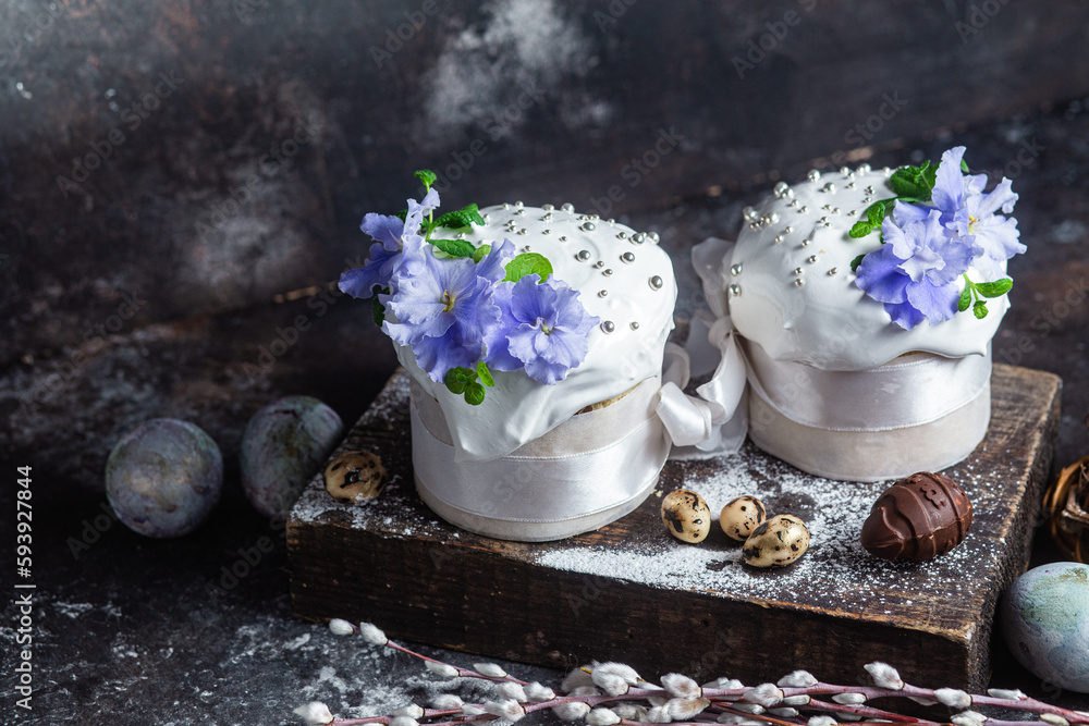 Easter cake with meringue and violets on a dark background Easter cake with meringue and violets on a dark background