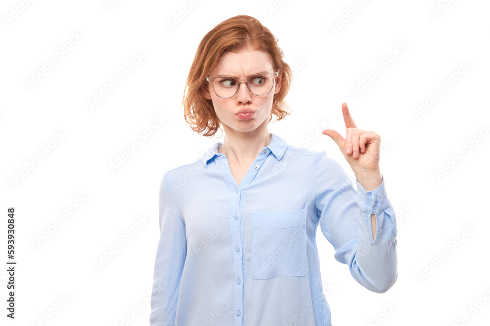 Portrait funny redhead young woman showing small size with fingers isolated on white studio background Portrait funny redhead young woman showing small size with fingers isolated on white studio background
