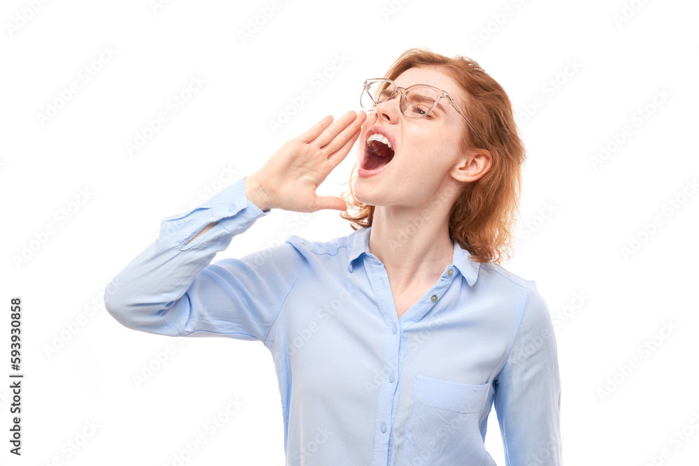 Portrait of redhead young woman screaming into her palms on white studio background. Important information, news concept Portrait of redhead young woman screaming into her palms on white studio background. Important information, news concept