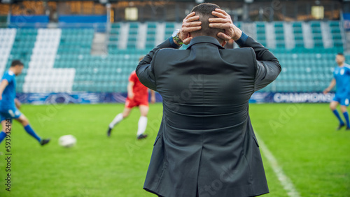 Professional Soccer Football Match Championship on Stadium with Disappointed Coach Drilling Players. Teams Attacks  Plays in Pass. Major League Cup World Tournament Concept. Back View