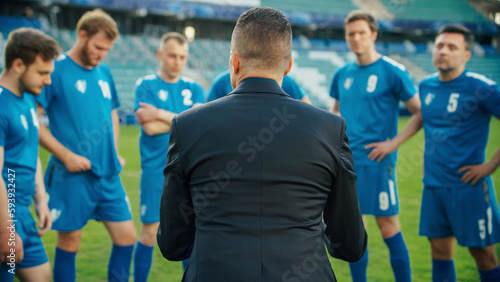 Professional Soccer Team Training, Tactical Coaching: Football Coach Explains Game Strategy, Develop Workout Plan Trainer Motivates Athletes, Leads to Victory, Preparing For Championship. Back View © Gorodenkoff