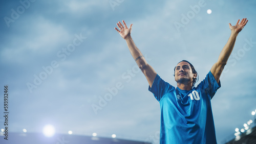 Football Match Championship: Portrait of Soccer Player Standing, Posing, Smiling, Raising Hands to Cheer. Professional Hispanic Footballer, Champion Ready to Win Cup, Tournament. Medium Shot